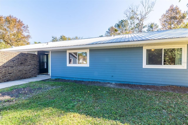 view of property exterior with a yard