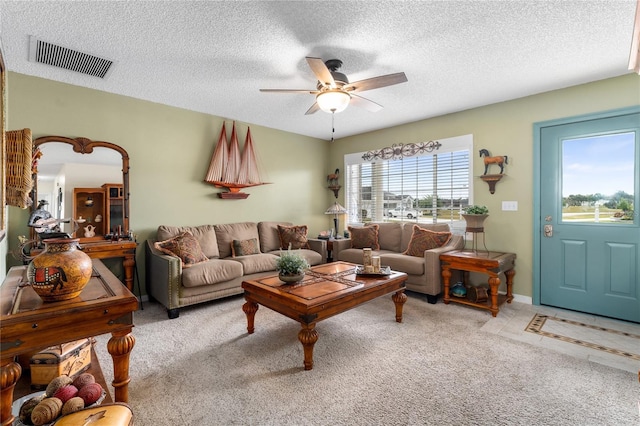 carpeted living room featuring a textured ceiling and ceiling fan