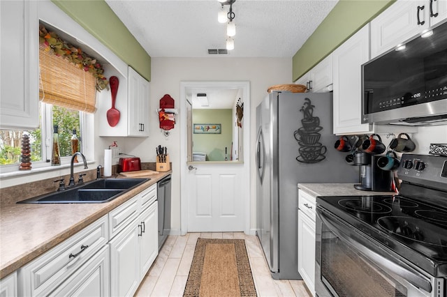 kitchen featuring sink, white cabinets, and stainless steel appliances