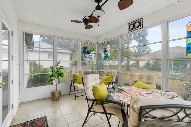 sunroom / solarium featuring ceiling fan