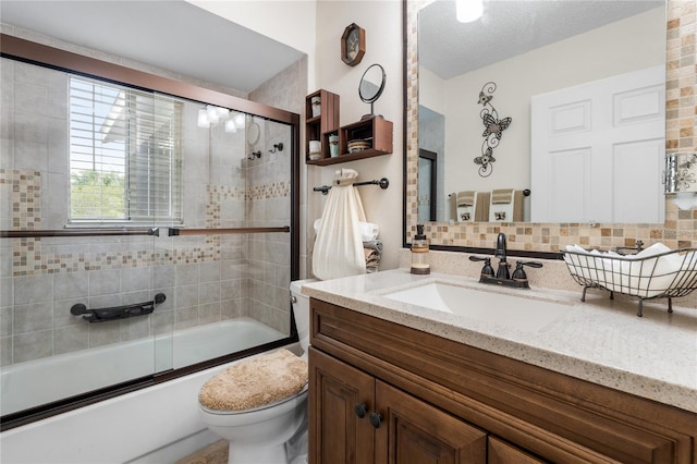 full bathroom with vanity, toilet, decorative backsplash, and bath / shower combo with glass door