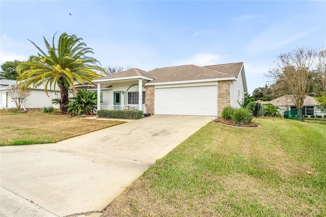 view of front of house featuring a porch, a garage, and a front yard