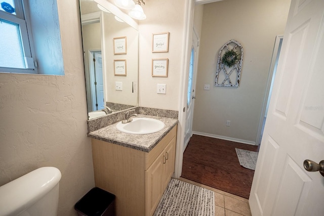 bathroom with tile patterned floors, vanity, and toilet