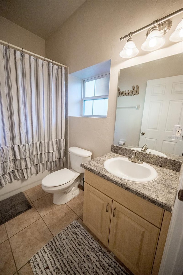 full bathroom featuring tile patterned flooring, vanity, toilet, and shower / bath combo with shower curtain