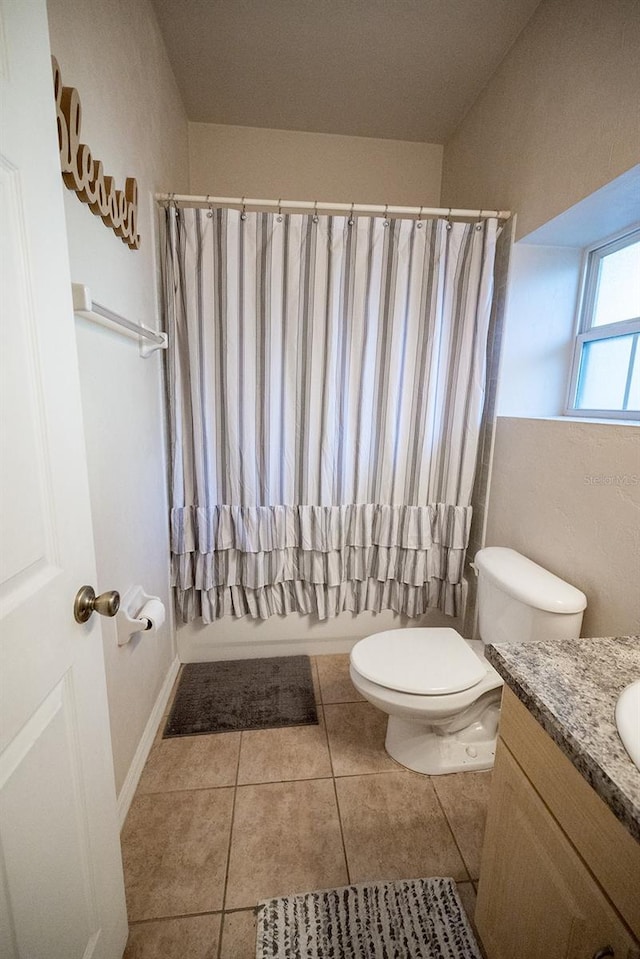 full bathroom with toilet, vanity, tile patterned floors, and shower / bath combo with shower curtain