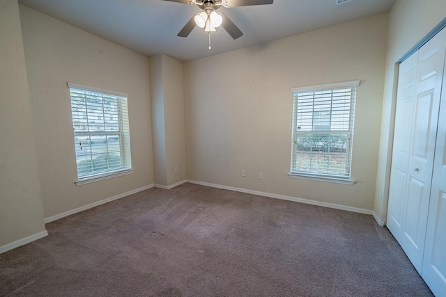 carpeted empty room featuring plenty of natural light and ceiling fan