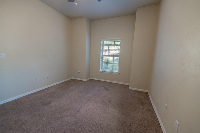 unfurnished room with ceiling fan and light carpet