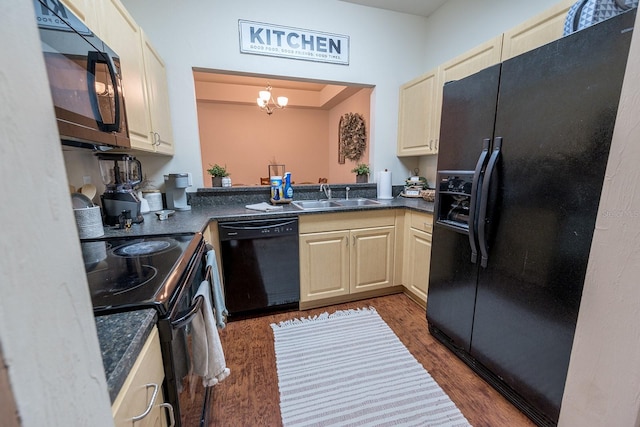 kitchen with dark wood-type flooring, sink, black appliances, decorative light fixtures, and a chandelier