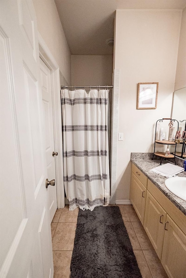 bathroom with vanity, tile patterned floors, and curtained shower