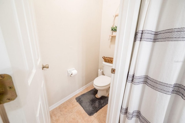 bathroom with tile patterned floors and toilet