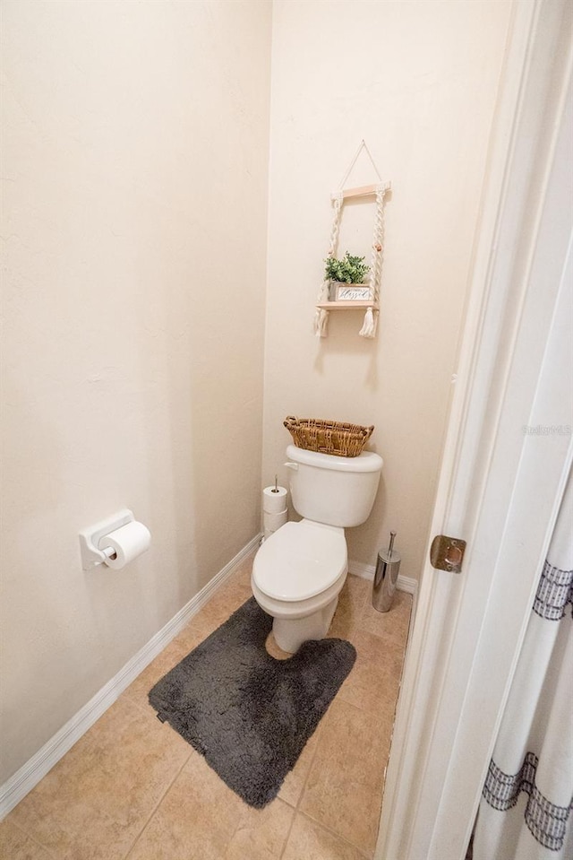 bathroom featuring tile patterned flooring and toilet