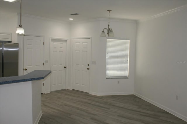 kitchen with dark hardwood / wood-style flooring, white cabinets, hanging light fixtures, and an inviting chandelier