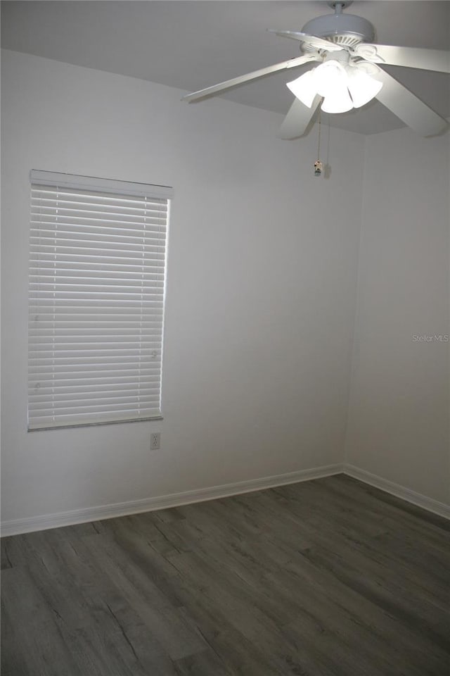 spare room featuring dark hardwood / wood-style floors and ceiling fan