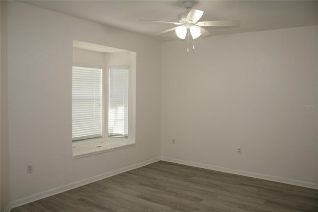 spare room featuring ceiling fan and dark hardwood / wood-style floors