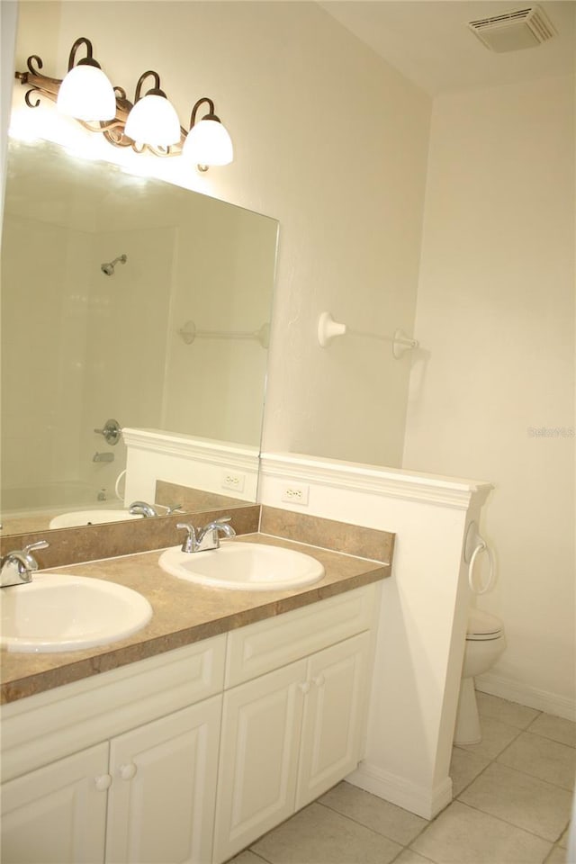 full bathroom featuring tile patterned floors, vanity, washtub / shower combination, and toilet