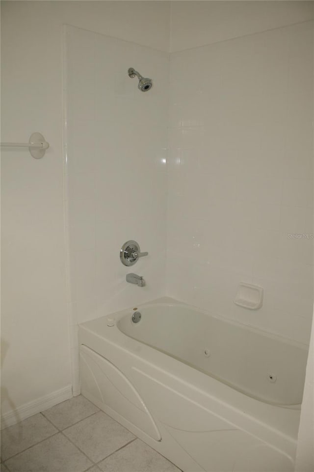 bathroom with tile patterned flooring and shower / washtub combination