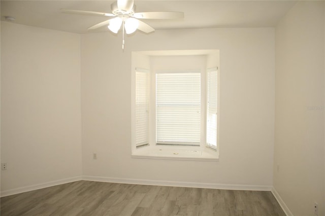 spare room featuring ceiling fan and hardwood / wood-style flooring