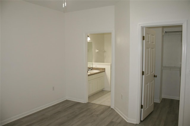 corridor featuring light hardwood / wood-style flooring and sink