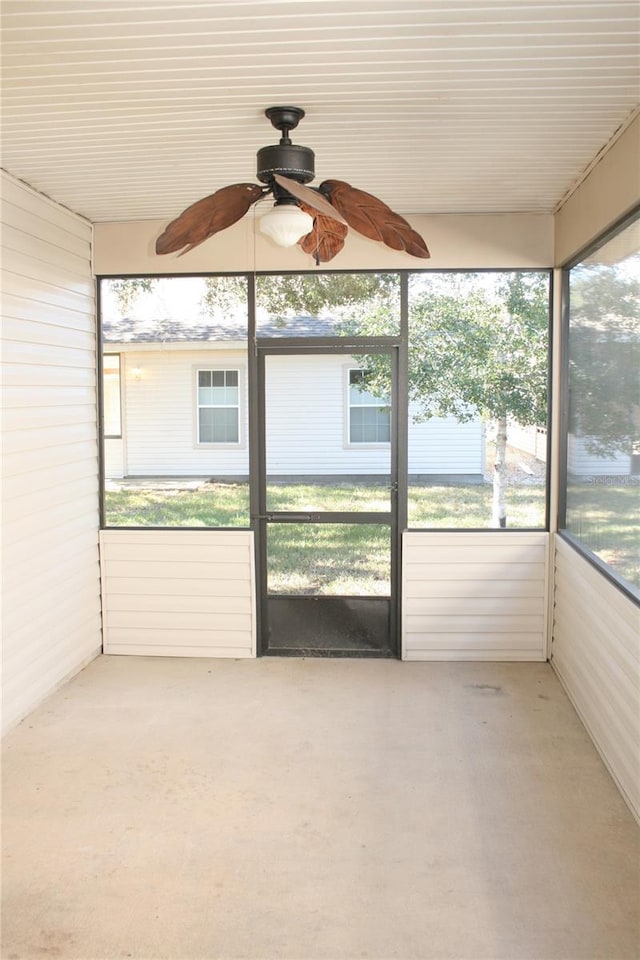 unfurnished sunroom featuring ceiling fan