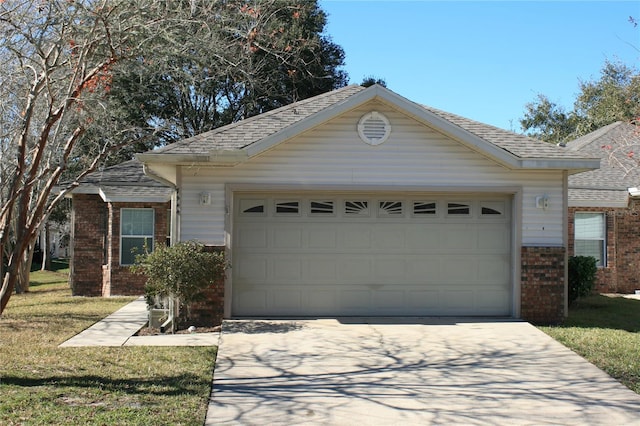 view of front of home with an attached garage, driveway, a front yard, brick siding, and a shingled roof