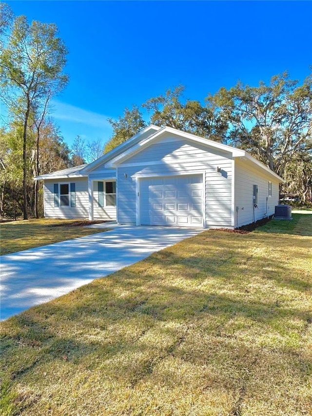 ranch-style house featuring cooling unit, a garage, and a front lawn