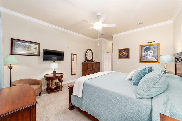 bedroom with light carpet, ornamental molding, a closet, and ceiling fan