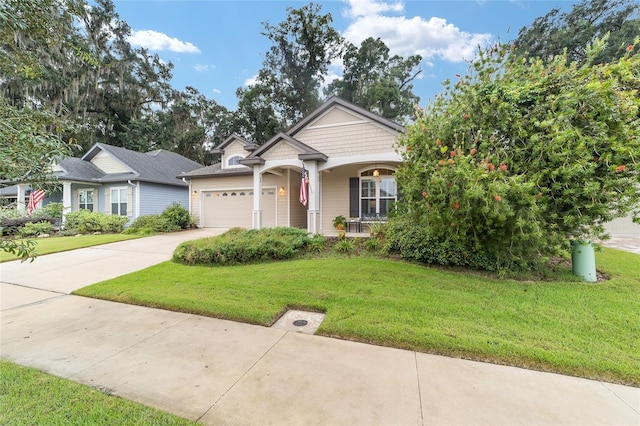 view of front of house featuring a garage, covered porch, and a front lawn