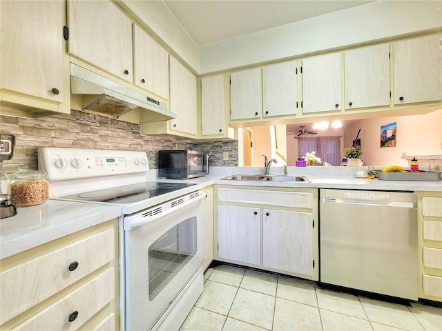 kitchen with sink, light tile patterned flooring, ceiling fan, decorative backsplash, and appliances with stainless steel finishes