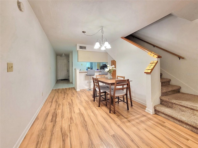 dining room featuring light hardwood / wood-style floors and an inviting chandelier