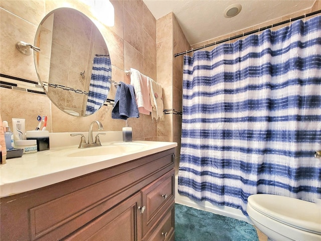 bathroom featuring tile walls, toilet, vanity, and a shower with curtain