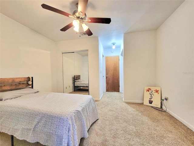 carpeted bedroom featuring a closet and ceiling fan