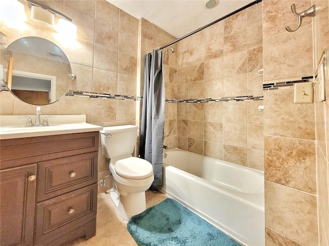 full bathroom featuring toilet, tile patterned flooring, tile walls, shower / bath combo, and vanity