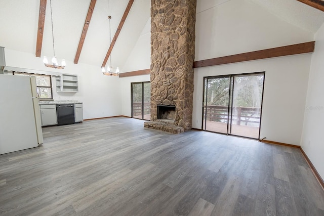 unfurnished living room with an inviting chandelier, a stone fireplace, beamed ceiling, high vaulted ceiling, and wood-type flooring