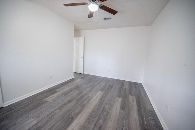 unfurnished room featuring a textured ceiling, ceiling fan, and dark wood-type flooring