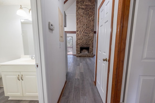 hallway featuring dark wood-type flooring and sink