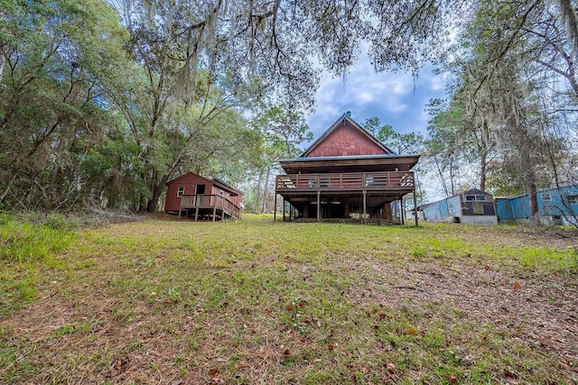 view of yard with an outdoor structure and a wooden deck