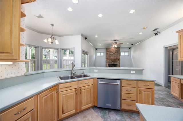 kitchen with kitchen peninsula, ceiling fan with notable chandelier, sink, a fireplace, and hanging light fixtures