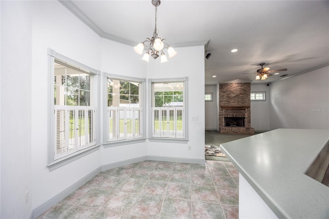 interior space featuring a healthy amount of sunlight, ornamental molding, and a brick fireplace