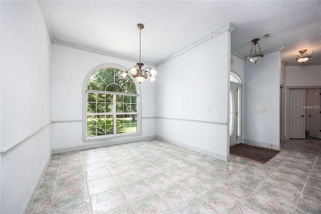 empty room with a textured ceiling, ornamental molding, and a notable chandelier