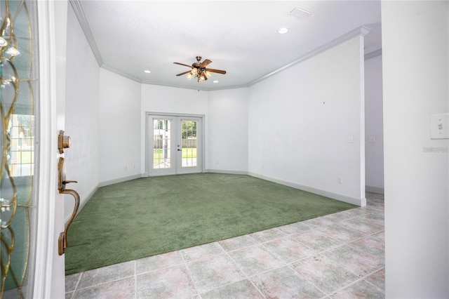 carpeted empty room featuring ceiling fan, crown molding, and french doors