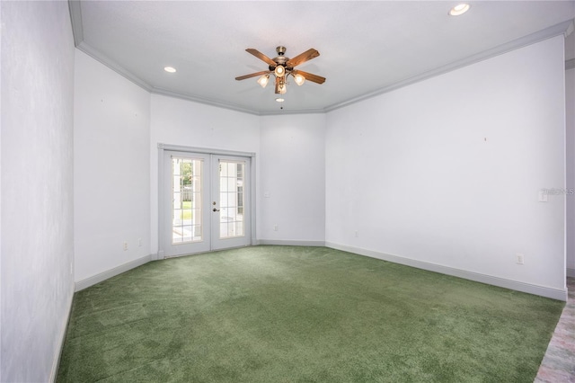 empty room featuring french doors, dark carpet, ceiling fan, and crown molding