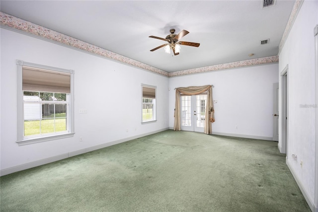 empty room featuring carpet flooring, french doors, and ceiling fan