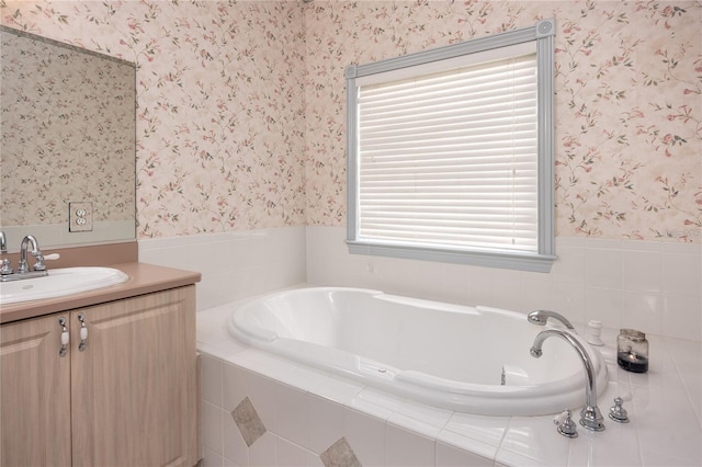 bathroom with vanity and tiled tub