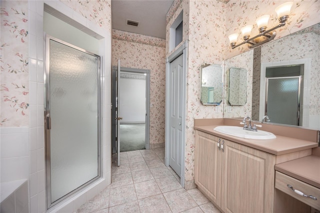 bathroom featuring tile patterned flooring, vanity, and a shower with shower door