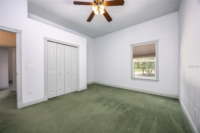 unfurnished bedroom featuring dark colored carpet, ceiling fan, and a closet