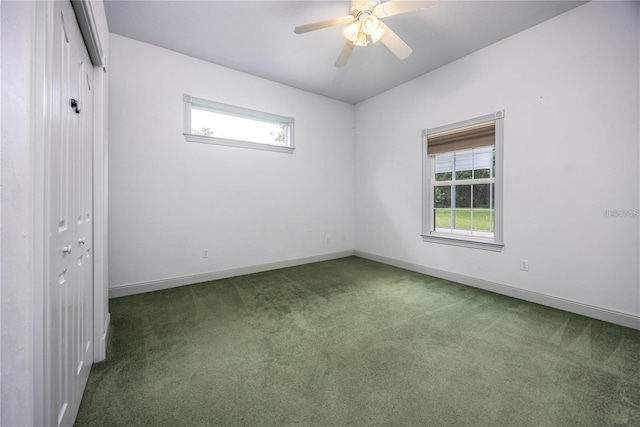 carpeted spare room featuring ceiling fan