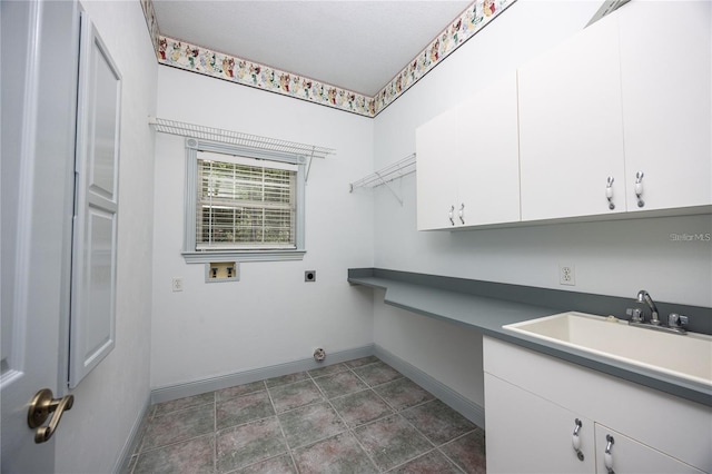 clothes washing area featuring cabinets, hookup for a washing machine, electric dryer hookup, and sink