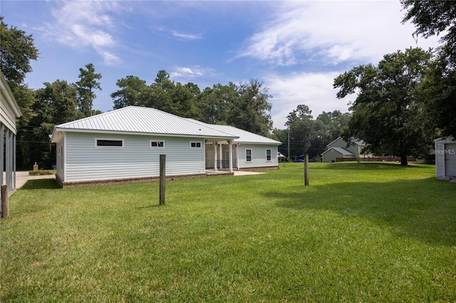 back of property featuring a lawn