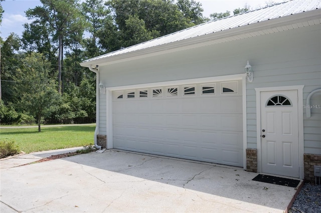 garage featuring a lawn