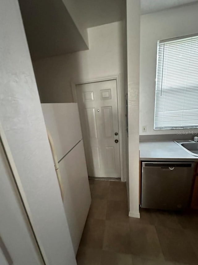 kitchen with sink, dishwasher, and white refrigerator